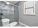 Modern bathroom featuring a tiled shower with glass door and a comfort height toilet at 2923 Cornell Ave, Orlando, FL 32804