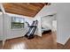 Bedroom with wood ceiling, wood floors, and fitness machine leading to another bedroom at 2923 Cornell Ave, Orlando, FL 32804