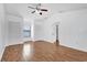 Bright bedroom featuring wood-look floors, a ceiling fan, and ample closet space at 2923 Cornell Ave, Orlando, FL 32804