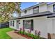 Charming two-story home featuring manicured landscaping with flowering bushes that lines the walkway at 2923 Cornell Ave, Orlando, FL 32804