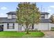 Charming two-story home featuring a well-manicured lawn and beautiful mature tree in the front yard at 2923 Cornell Ave, Orlando, FL 32804