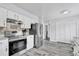Bright eat-in kitchen features stainless steel appliances, light countertops, and modern backsplash at 2923 Cornell Ave, Orlando, FL 32804