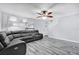 Bright living room features a large window, ceiling fan, and comfortable leather sofa at 2923 Cornell Ave, Orlando, FL 32804