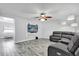Bright living room features a large window, ceiling fan, comfortable leather sofa, and entertainment center at 2923 Cornell Ave, Orlando, FL 32804