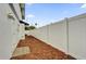 Narrow side yard featuring a privacy fence, fresh mulch, and access to the back of the property at 2923 Cornell Ave, Orlando, FL 32804