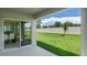 Backyard view showing the patio, yard and fence line with view into dining area at 2980 Moulin Rd, Davenport, FL 33837