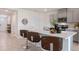 Kitchen featuring barstool seating, quartz countertops, stainless steel appliances, and ample cabinet space at 2980 Moulin Rd, Davenport, FL 33837