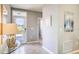 Light-filled foyer with tile flooring, decorative mirror, and a view of the front door at 2981 Moulin Rd, Davenport, FL 33837