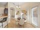 Bright dining area with tile floors features decorative lighting and access to the back patio at 330 Hickory Springs Ct, Debary, FL 32713