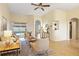 Bright living room featuring neutral decor, tile floors, and sliding doors to the pool at 330 Hickory Springs Ct, Debary, FL 32713