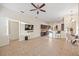 Open-concept living room features tile floors, ceiling fan, and views to the kitchen and dining area at 330 Hickory Springs Ct, Debary, FL 32713