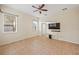 Spacious living room with tile floors, ceiling fan, and multiple windows for natural light at 330 Hickory Springs Ct, Debary, FL 32713