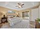 Primary bedroom with a ceiling fan, an area rug, and sliding glass doors leading to the pool at 330 Hickory Springs Ct, Debary, FL 32713