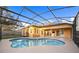 A beautiful outdoor pool with a screened enclosure with the house and sky as a beautiful backdrop at 330 Hickory Springs Ct, Debary, FL 32713