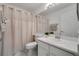 The bathroom features white cabinets, a sink, and a shower with a curtain at 338 Silver Pine Dr, Lake Mary, FL 32746