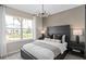 Comfortable bedroom featuring a large window, modern lighting fixture, and stylish decor at 3438 Orange Rose Loop, Apopka, FL 32712