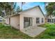 Home's backyard featuring a concrete patio with a view of house and green lawn at 350 Lakebreeze Cir, Lake Mary, FL 32746