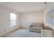 Well-lit bedroom with a window, couch, and neutral color palette at 350 Lakebreeze Cir, Lake Mary, FL 32746