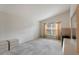 A bedroom featuring a high ceiling, a window, and a neutral color scheme at 350 Lakebreeze Cir, Lake Mary, FL 32746