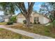 Single-Gathering home featuring a large tree, attached garage, and front lawn landscaping at 350 Lakebreeze Cir, Lake Mary, FL 32746