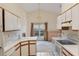 Functional kitchen featuring white countertops and cabinets, flowing into the living room at 350 Lakebreeze Cir, Lake Mary, FL 32746