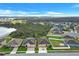 An aerial view of the neighborhood, featuring manicured lawns and a scenic pond at 3504 Cayugas Loop, St Cloud, FL 34772