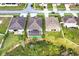 An aerial view showing backyard of home with screened in porch backing up to green space at 3504 Cayugas Loop, St Cloud, FL 34772