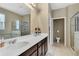 Luxurious bathroom with double vanity, soaking tub, glass-enclosed shower, and elegant finishes at 3504 Cayugas Loop, St Cloud, FL 34772