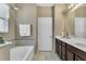 This bathroom features a soaking tub and double sink vanity at 3504 Cayugas Loop, St Cloud, FL 34772