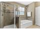 Spa-like bathroom features a glass shower, soaking tub, and modern fixtures for ultimate relaxation at 3504 Cayugas Loop, St Cloud, FL 34772