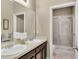 This bathroom features a double sink vanity and glass shower at 3504 Cayugas Loop, St Cloud, FL 34772