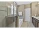 This bathroom features a glass shower, soaking tub, and double sink vanity at 3504 Cayugas Loop, St Cloud, FL 34772