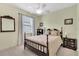 The bedroom boasts a ceiling fan, neutral walls, and a traditional dark wood bed frame at 3504 Cayugas Loop, St Cloud, FL 34772