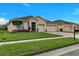 A one story home with a three car garage and manicured front lawn at 3504 Cayugas Loop, St Cloud, FL 34772