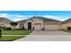 Inviting single-story home with a well-manicured lawn and two-car garage at 3504 Cayugas Loop, St Cloud, FL 34772