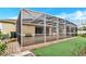 A screened-in patio featuring brick pavers and lush landscaping, offering an ideal outdoor living space at 3504 Cayugas Loop, St Cloud, FL 34772