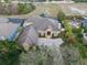 Aerial view of a spacious home with a screened pool, manicured landscaping, and an inviting driveway at 3569 Bellington Dr, Orlando, FL 32835