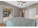 Bedroom featuring a ceiling fan and sliding glass doors to an outdoor patio at 3569 Bellington Dr, Orlando, FL 32835