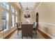 Elegant dining room with coffered ceilings, wainscoting, a chandelier, and large windows at 3569 Bellington Dr, Orlando, FL 32835