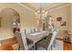 Dining area featuring a coffered ceiling, chandelier, archways, and a view into other living spaces at 3569 Bellington Dr, Orlando, FL 32835