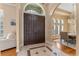 Welcoming foyer leading to a dining area, featuring a tiled entrance and double doors at 3569 Bellington Dr, Orlando, FL 32835