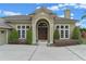 Inviting front exterior featuring a stately entrance with large double doors and manicured shrubs at 3569 Bellington Dr, Orlando, FL 32835