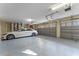 Well-lit two-car garage showcases a white car and a garage door, offering secure parking and storage at 3569 Bellington Dr, Orlando, FL 32835