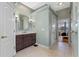 Stylish bathroom with a dark wood vanity, modern fixtures, and neutral tile flooring at 3569 Bellington Dr, Orlando, FL 32835