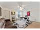 Office space featuring a ceiling fan, desk with a leather office chair, and a brown leather couch at 3569 Bellington Dr, Orlando, FL 32835