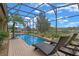 Enclosed pool area with brick pavers, lounge chairs, and a palm tree, offering a serene outdoor retreat at 3569 Bellington Dr, Orlando, FL 32835