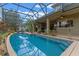 An inviting swimming pool enclosed within a screen, featuring lush landscaping and a relaxing outdoor space at 3569 Bellington Dr, Orlando, FL 32835