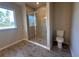 Bathroom featuring a glass-enclosed shower, tile flooring, and natural light at 3660 Pandora Dr, Indian Lake Estates, FL 33855