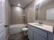 Clean bathroom featuring tile surround shower, toilet, vanity, and wood-look tile floor at 3660 Pandora Dr, Indian Lake Estates, FL 33855