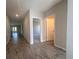 Hallway with wood look tile, neutral walls and bright lighting at 3660 Pandora Dr, Indian Lake Estates, FL 33855